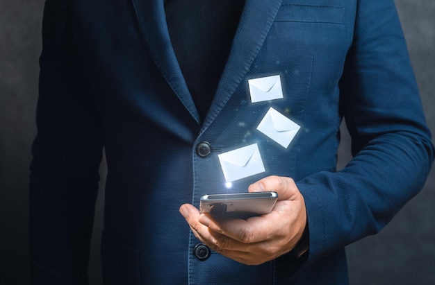 Man hands using cellphone with flying envelopes close up businessman hand touchscreen on smartphone devices for received unread email listing or sending mail to partner and customer