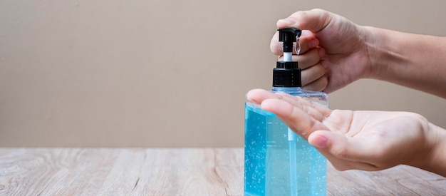 Man hands using wash hand alcohol gel or sanitizer bottle