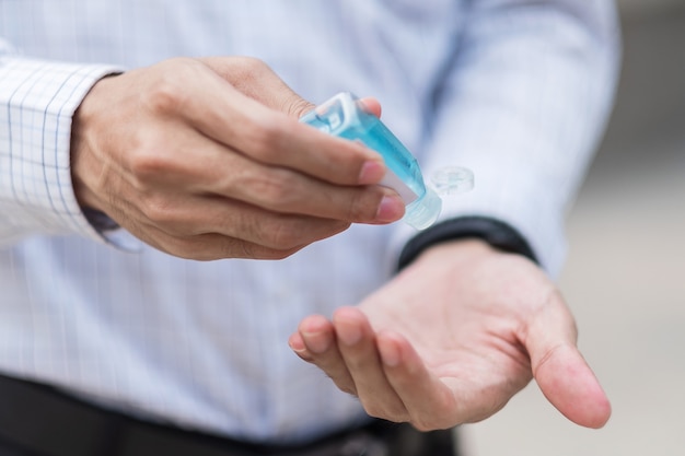 Man hands using wash hand sanitizer gel dispenser, against Novel coronavirus or Corona Virus Disease (Covid-19)