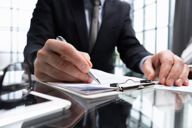 Photo man hands with pen writing on notebook in the officelearning education and work