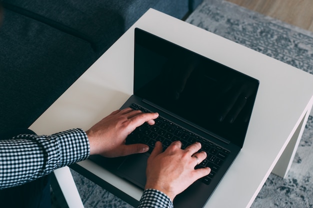 Man hands working on computer at home