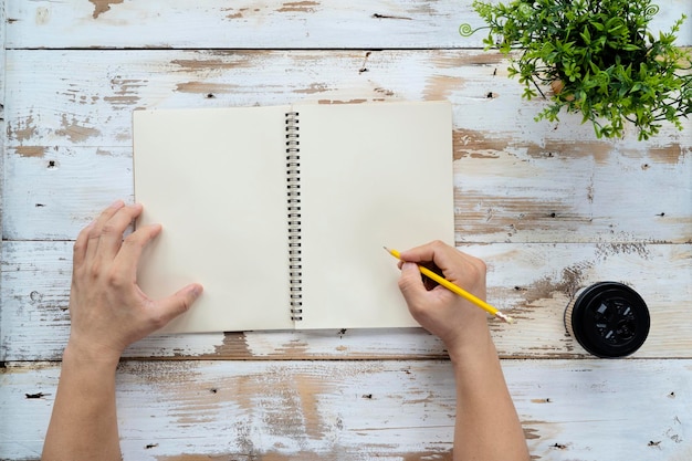 Man hands writing on book in office