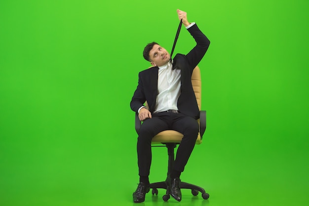 The man hanging himself for a tie on the green background