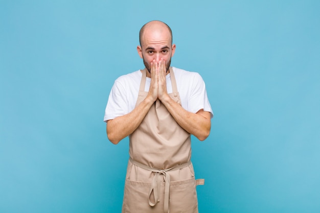 Man happy and excited, surprised and amazed covering mouth with hands