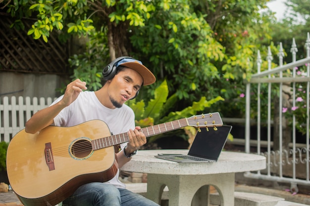 Man happy playing Acoustic Guitar at home