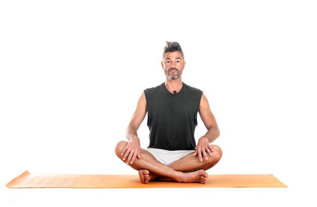 Photo man and hatha yoga asana in front of white background