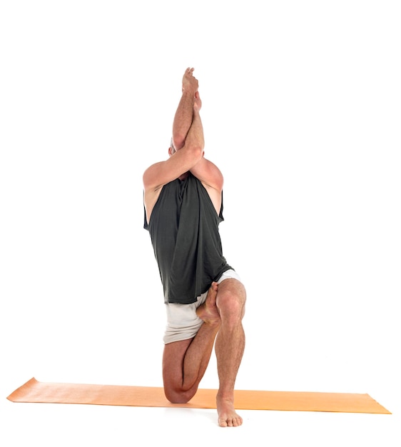 Photo man and hatha yoga asana in front of white background