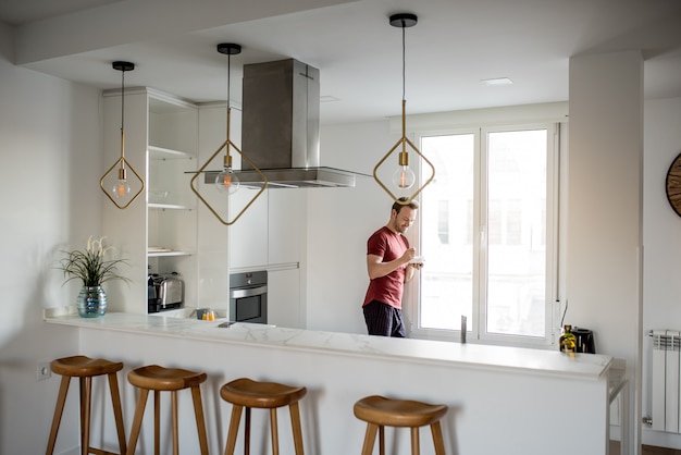 Man having breakfast by the windows