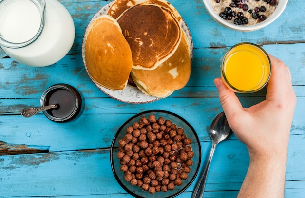 Man having breakfast with cereal chocolate balls