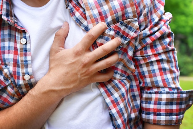 Man having chest pain heart attack outdoors