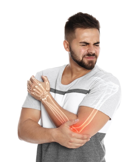 Man having elbow pain on white background Digital compositing with illustration of arm bones