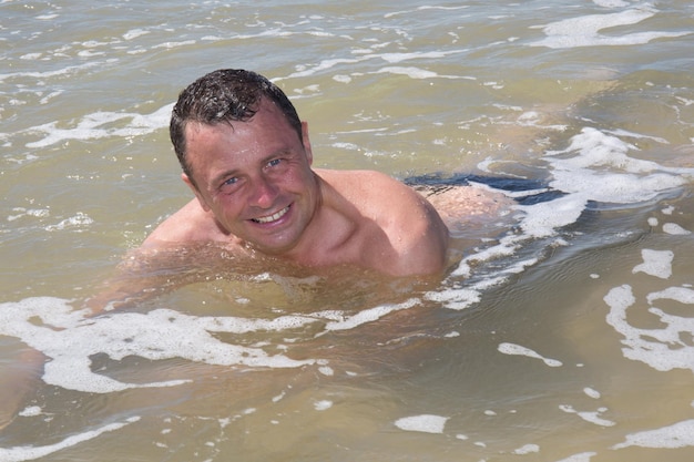 Man having fun at the beach during summertime