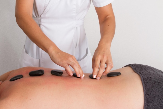 Man having a hot stone massage at spa center