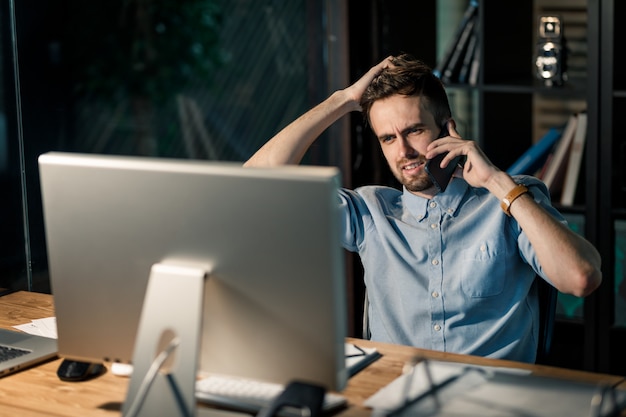 Man having phone call late in office