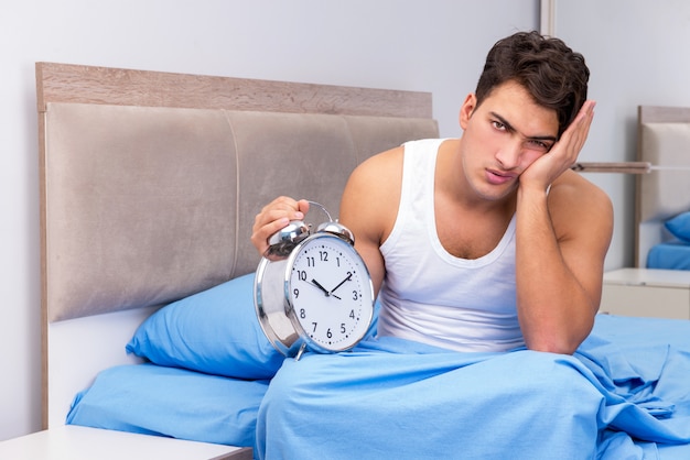 Man having trouble waking up in morning