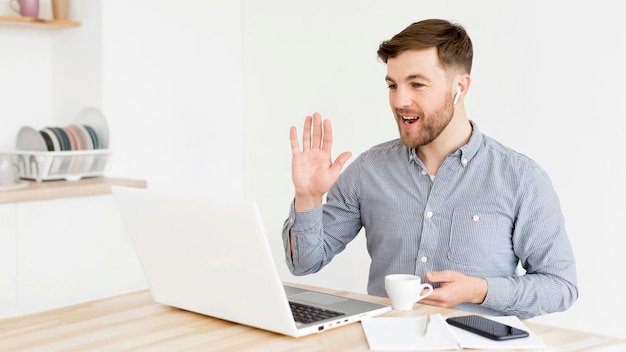 Photo man having video conference on laptop