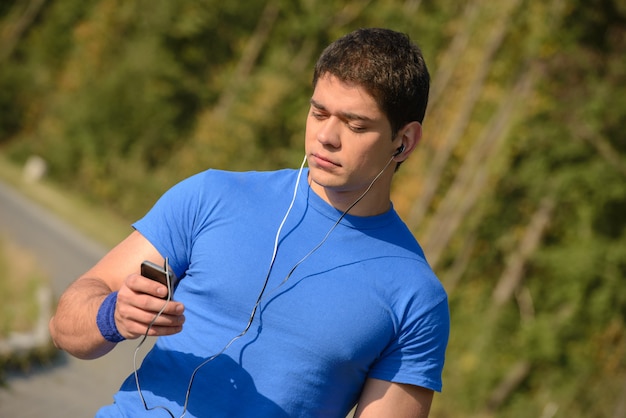 A man in headphones chooses a song to run.