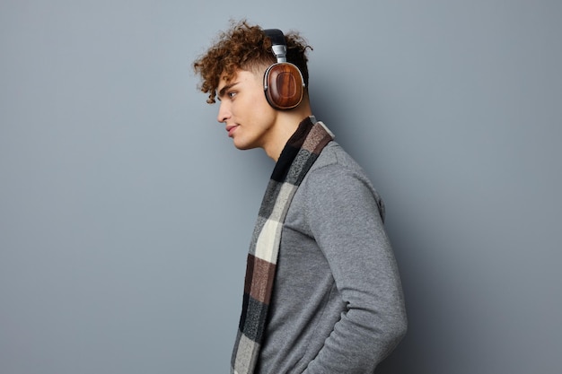 Man in headphones on gray background