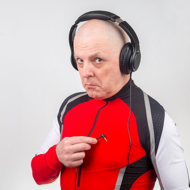 Man in headphones is looking for the entrance of his heart to listen to music.