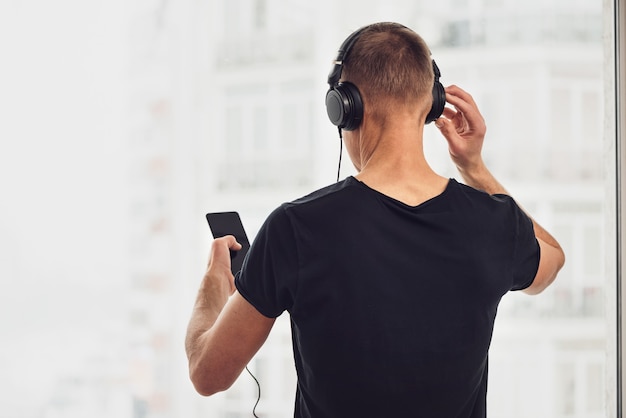 The man in headphones and with a smartphone