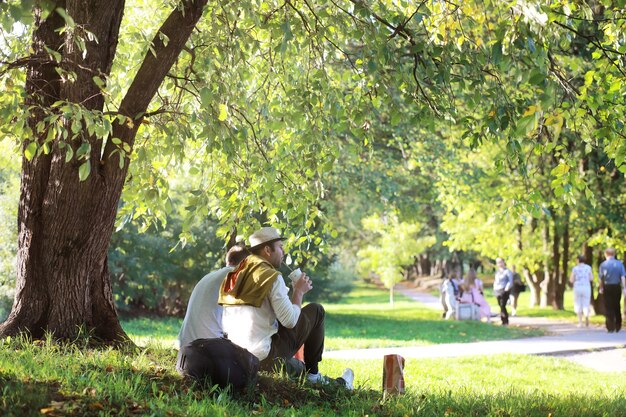 A man hides in the shade of trees on a hot day. lunch break.
rest in the middle of the working day.