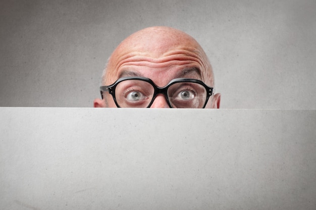 Man hiding behind a board