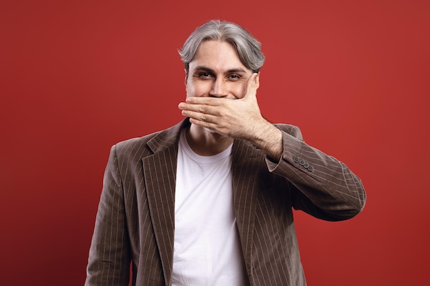 man hiding his smile with his hand