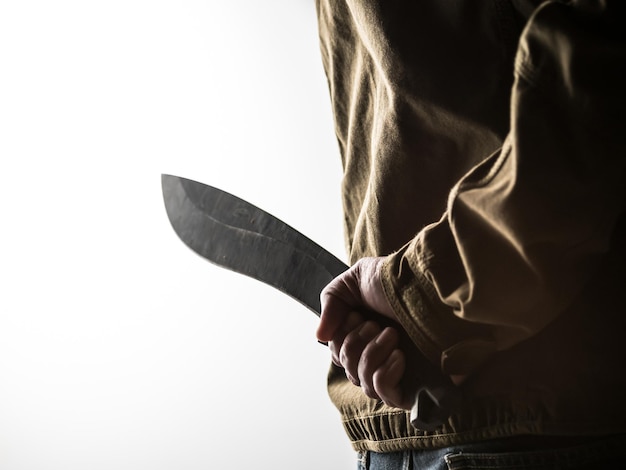 Man hiding a machete behind his back