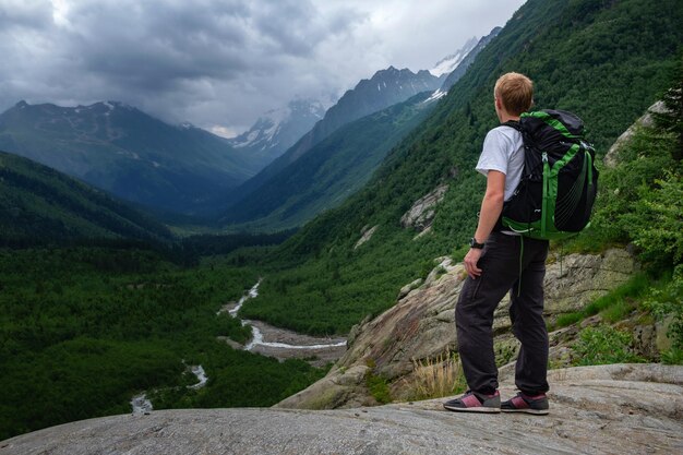 Man hiking at mountains with heavy backpack