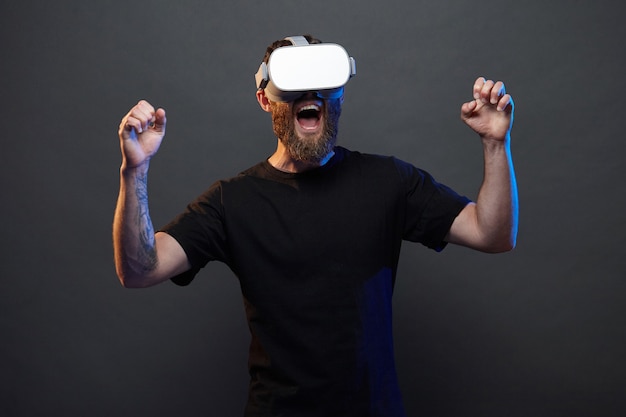 Man hipster with beard using virtual reality glasses