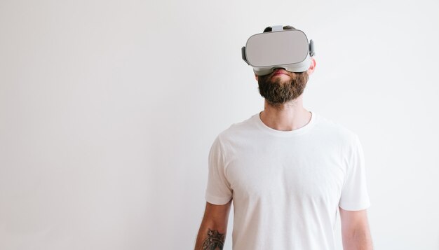 Man hipster with beard using virtual reality glasses