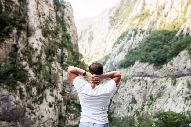 Man on his back looking at a valley