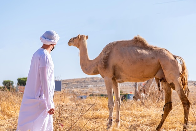 Man and his camel enjoying their time in the village