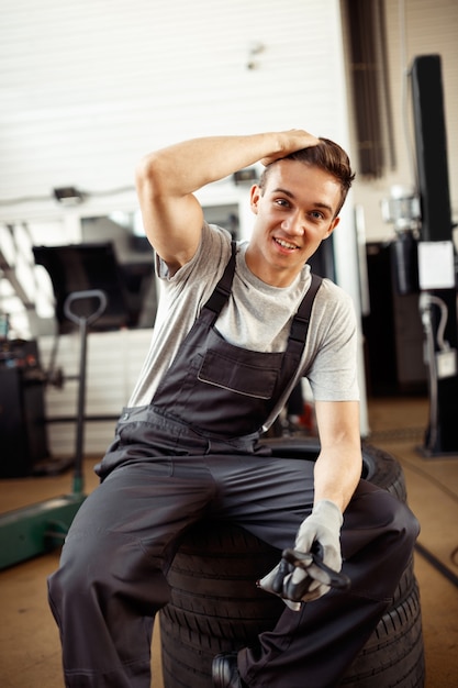 A man at his work at autoservice during a break.