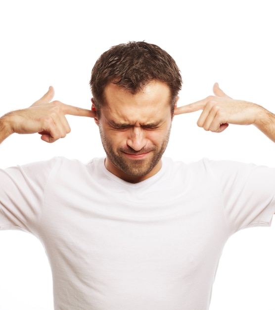 Man hold hands on temples ears, concept of man stressed, headache, depressed, pain, closed eyes wear white t-shirt, isolated on white.