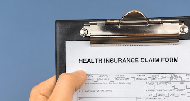 Photo man hold health insurance claim form in clipboard. banner. medicine document concept photo