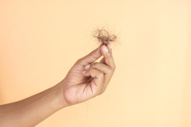 man hold his list hair close up