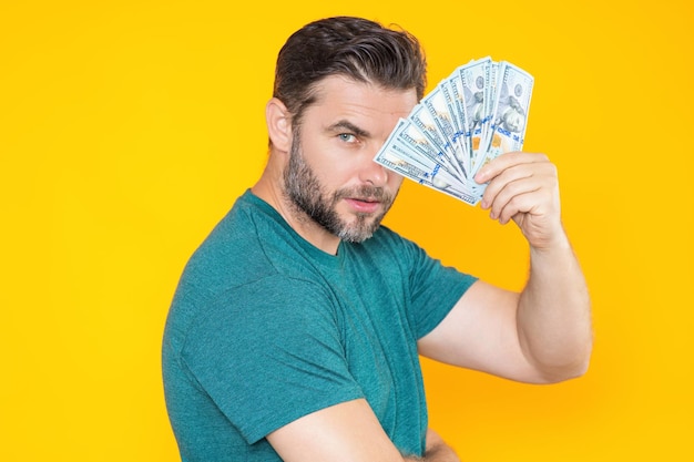 Man hold money on yellow studio isolated background portrait of rich man with money dollar bills