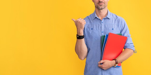 Man hold school notebook or planner pointing finger directing