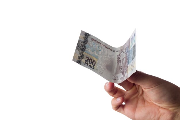 Man holding 200 reais bills isolated on white. Brazilian money. paying.