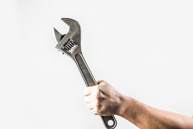 Man holding an adjustable wrench