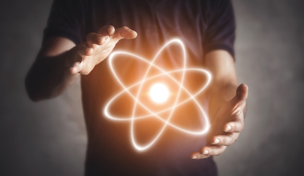 Man holding atom