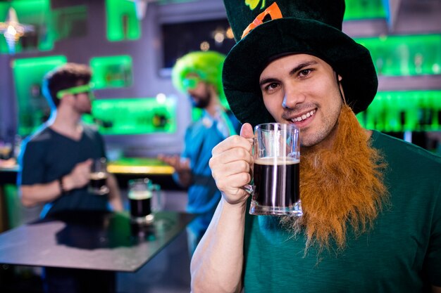 Man holding beer glass and smiling