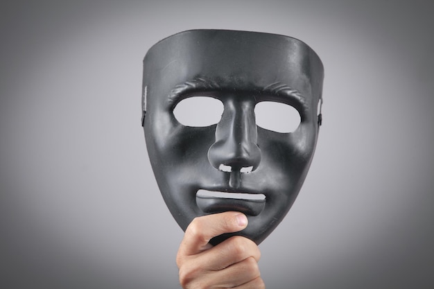 Man holding black mask Fake anonymous