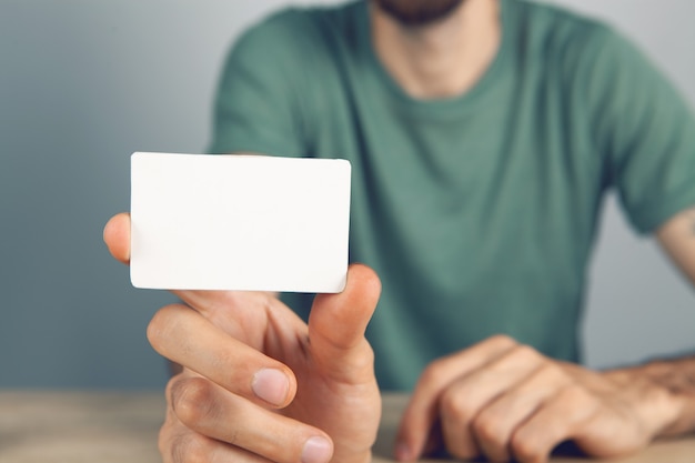 Man holding blank advertising paper