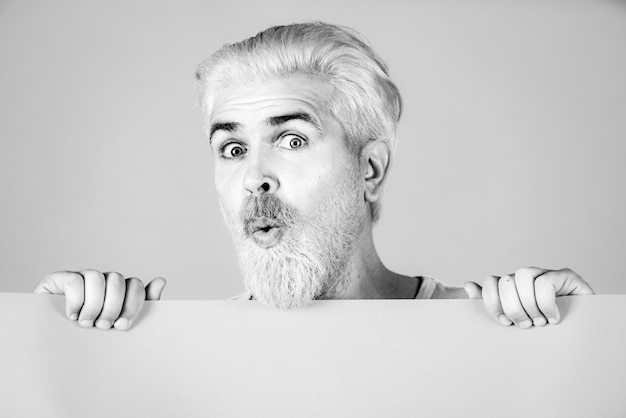 Man holding a blank billboard isolated on background