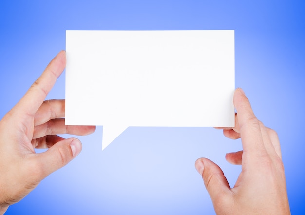 Man holding blank paper speech bubble