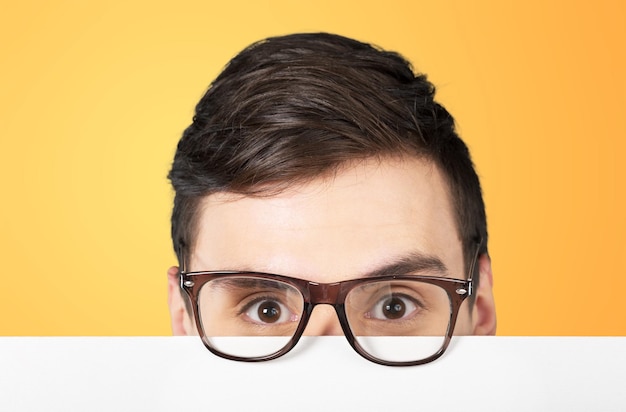 Man holding blank white paper over his face