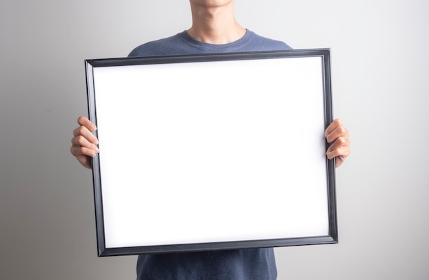 Man holding blank whiteboard