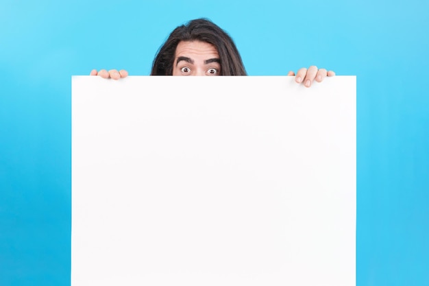 Man holding a board with blank space